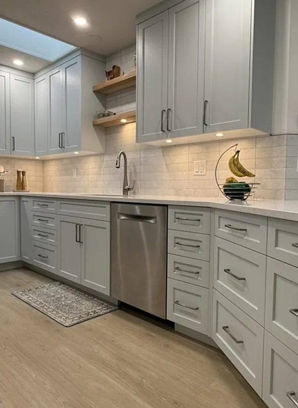 A pale grey shaker kitchen designed in 3D first, with a skylight, open wood shelving and full-height storage