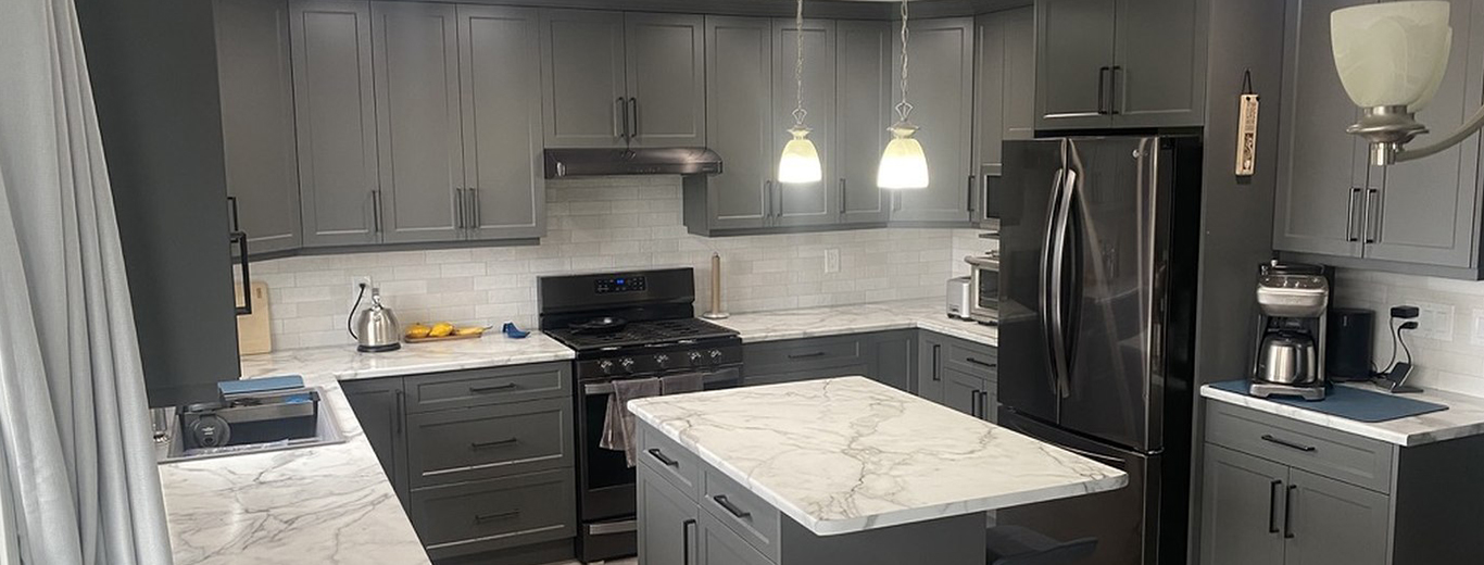 A Nanaimo kitchen after refacing, with grey shaker doors, new hardware and a marble-look island