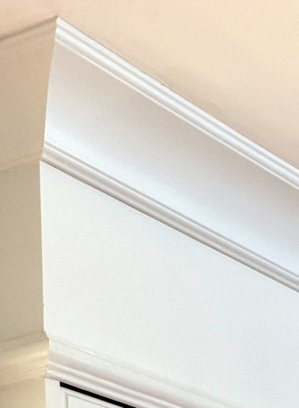 Painted crown moulding finished tight to the ceiling above refaced cabinets