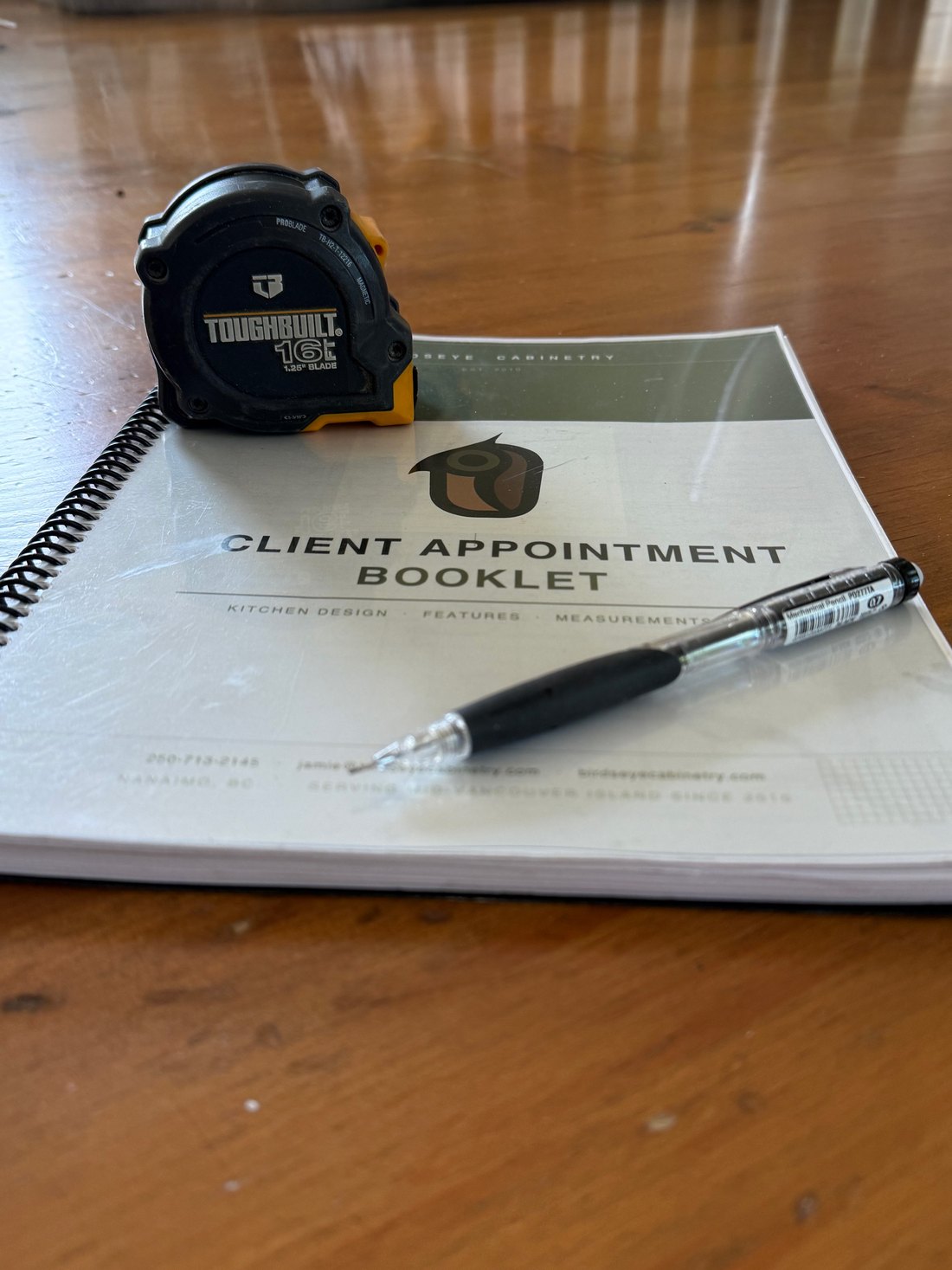 Birdseye client appointment booklet and tape measure on a kitchen table